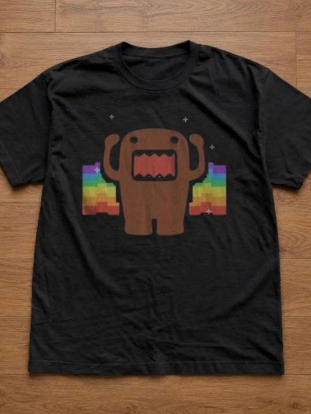 Black T‑Shirt with Brown Domo Character and Rainbow Pixel Wings